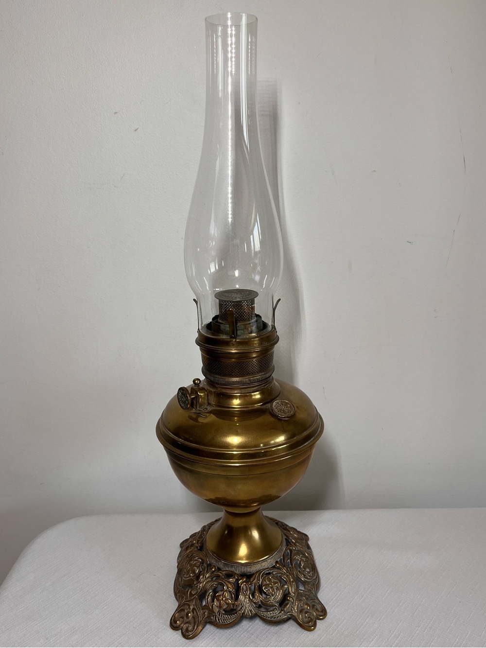 Vintage brass kerosene oil lamp, 1910, ornate cast iron base, glass chimney, USA